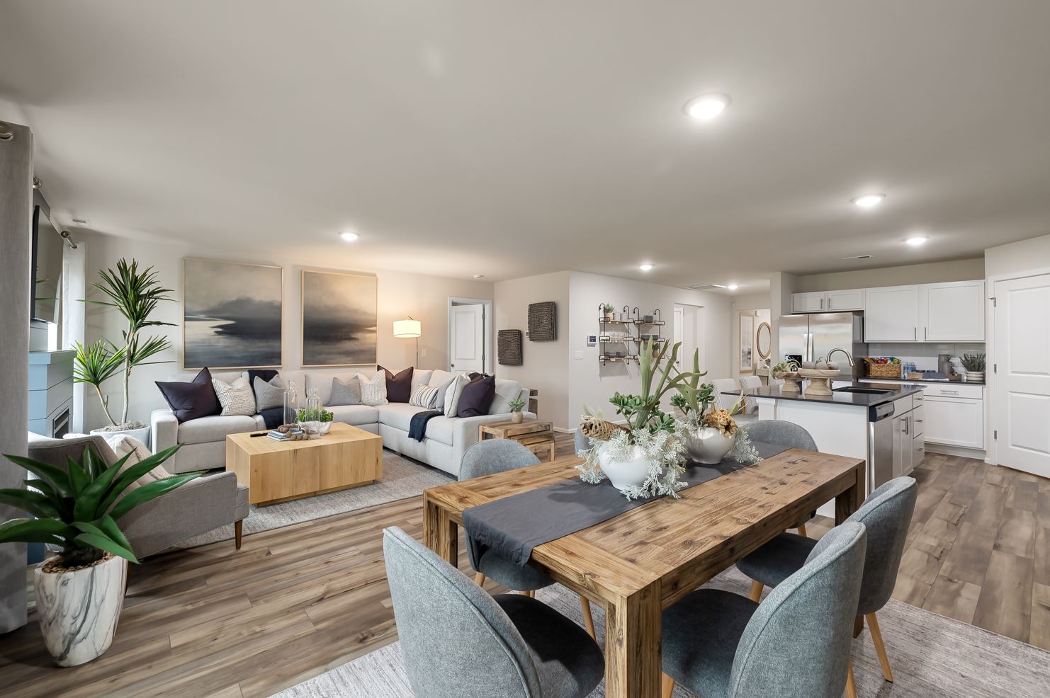 A living room with a table and chairs.