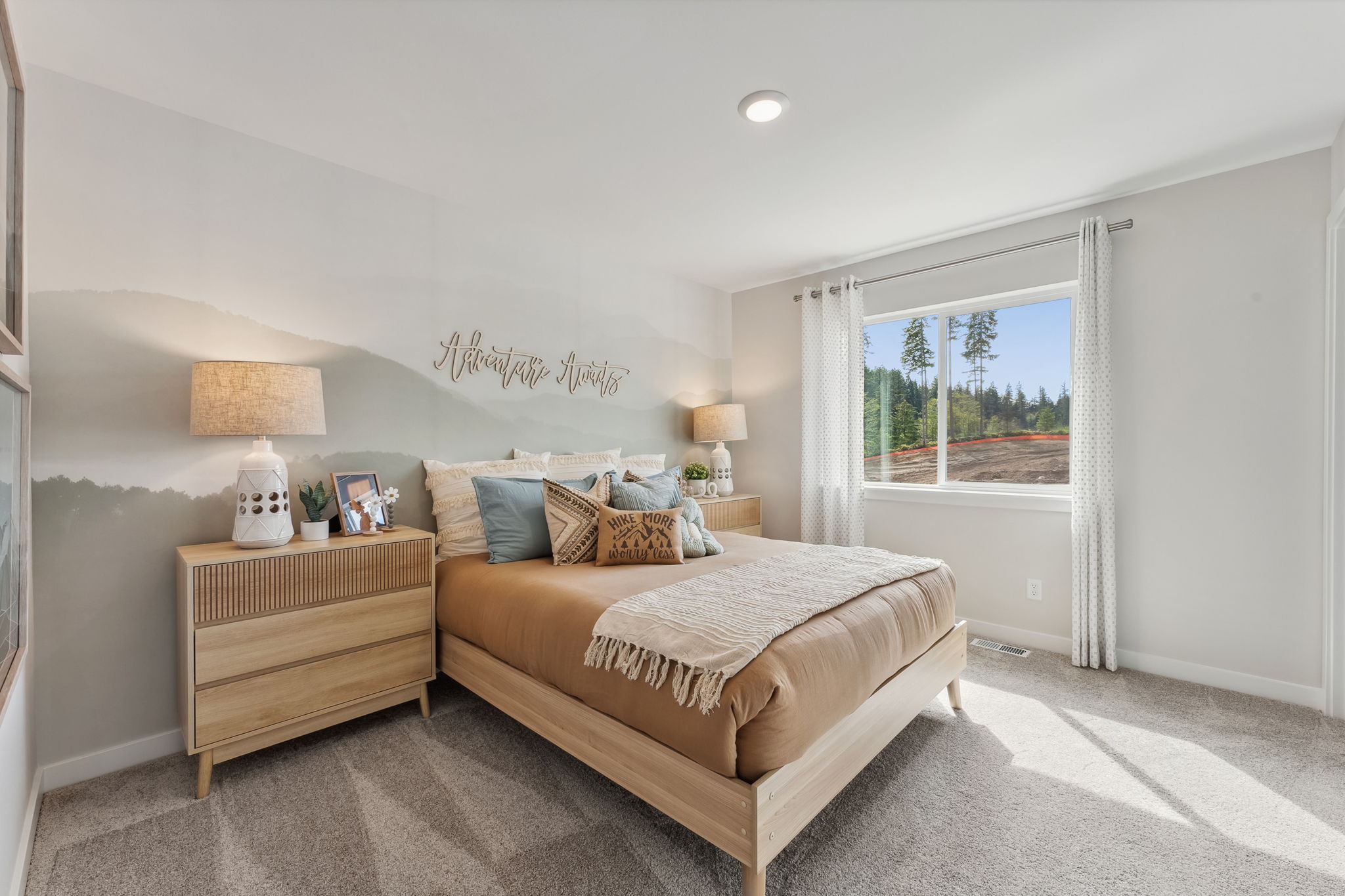 A bedroom with a bed and lamps.