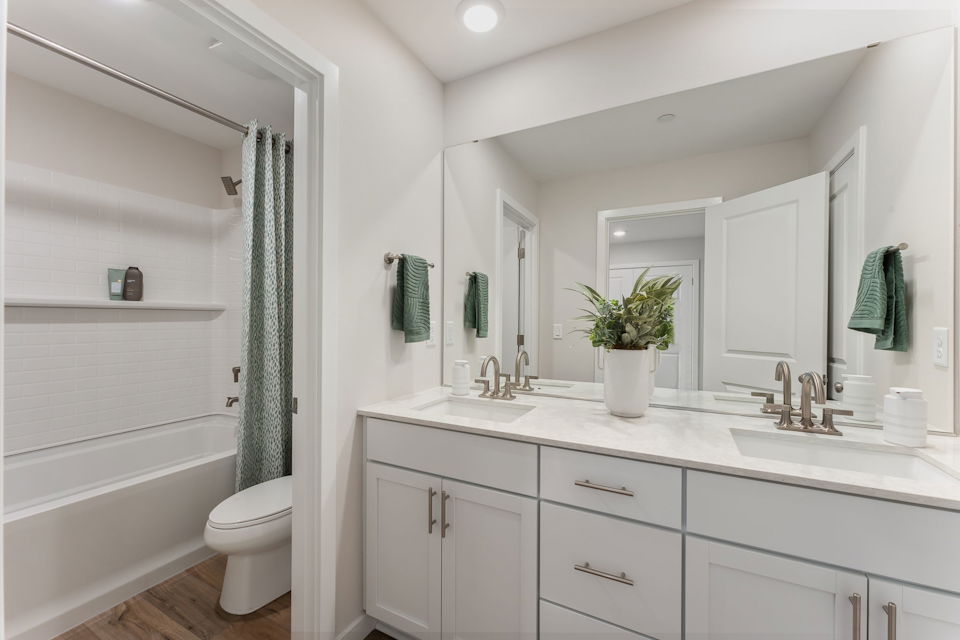 A bathroom with a tub sink and toilet.
