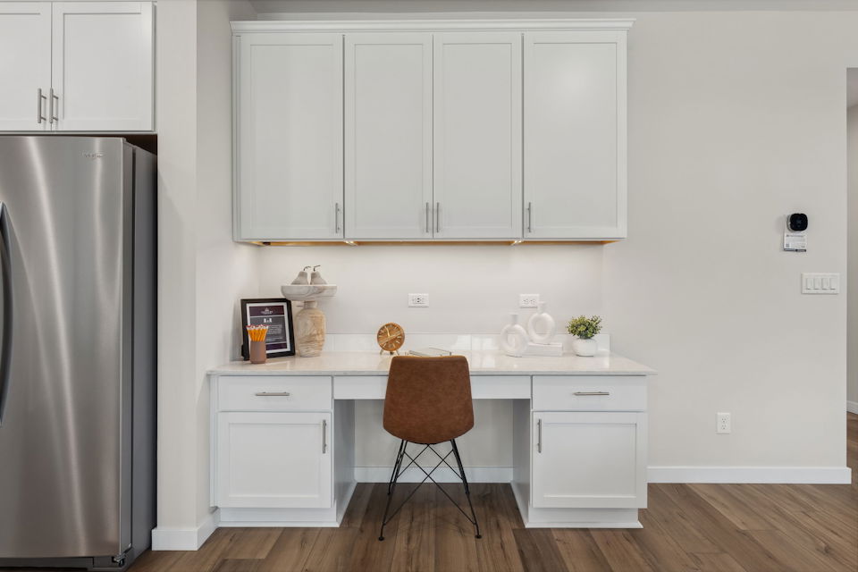 A kitchen with white cabinets.