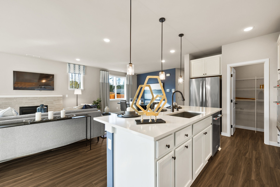 A kitchen with white cabinets.