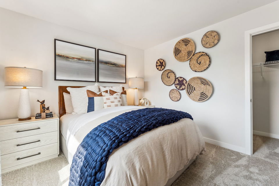 A bedroom with a bed and lamps.