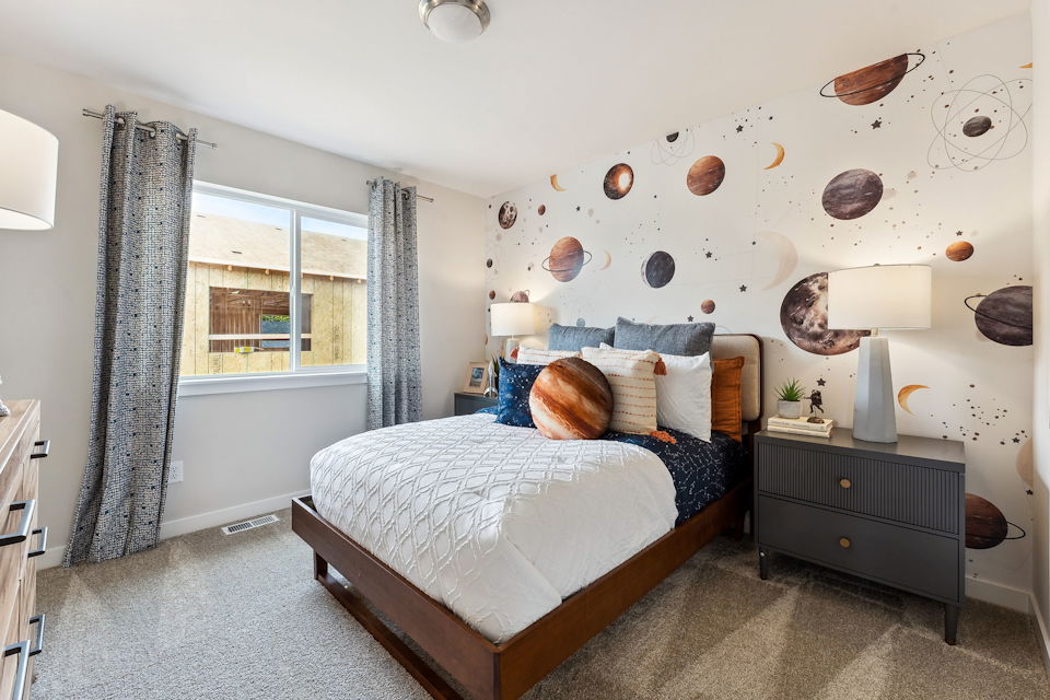 A bedroom with a bed and a window.