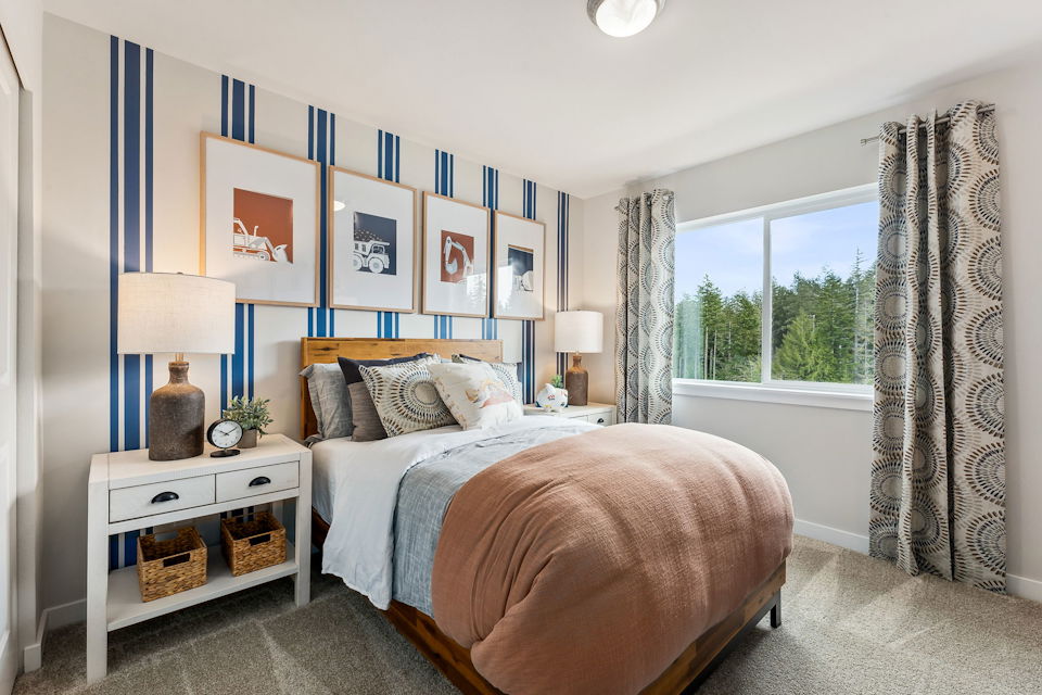 A bedroom with a bed and a window.