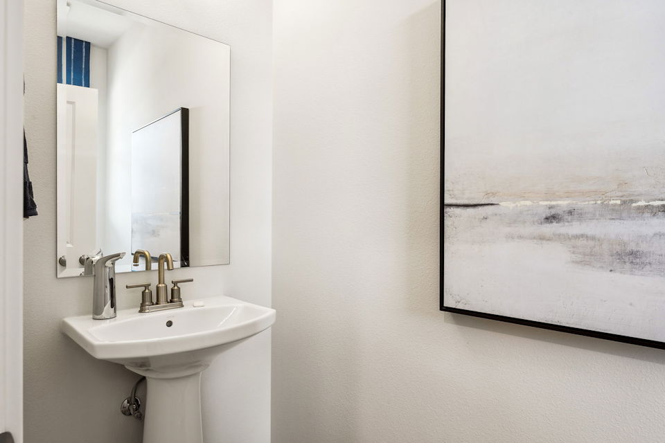 A bathroom with a sink and a mirror.