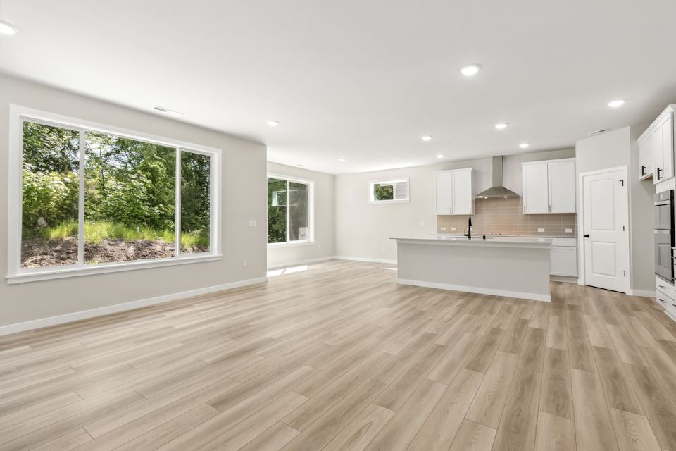 A large kitchen with a wood floor.