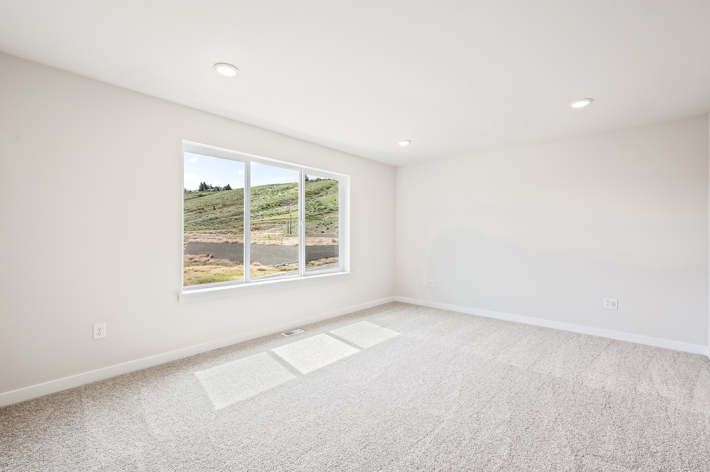 A room with a window and a tile floor.