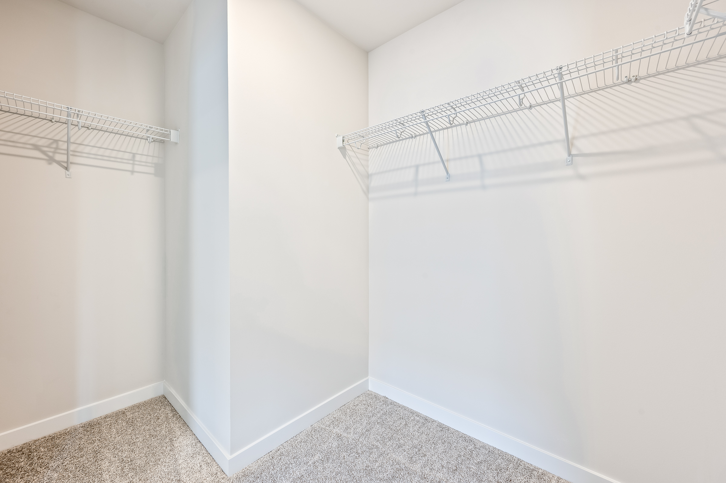 A white wall with a metal railing.