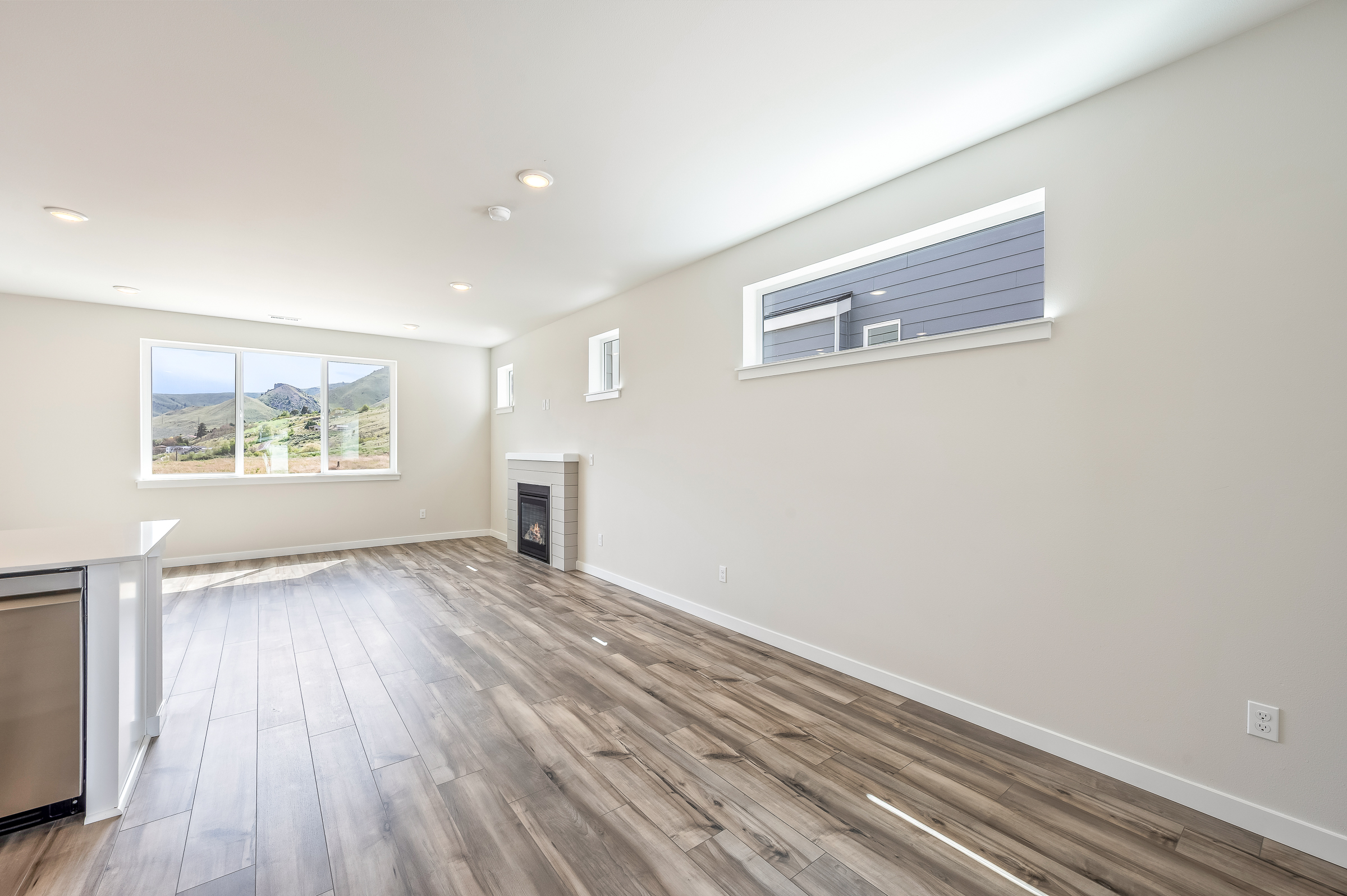 A room with a wood floor and a window.