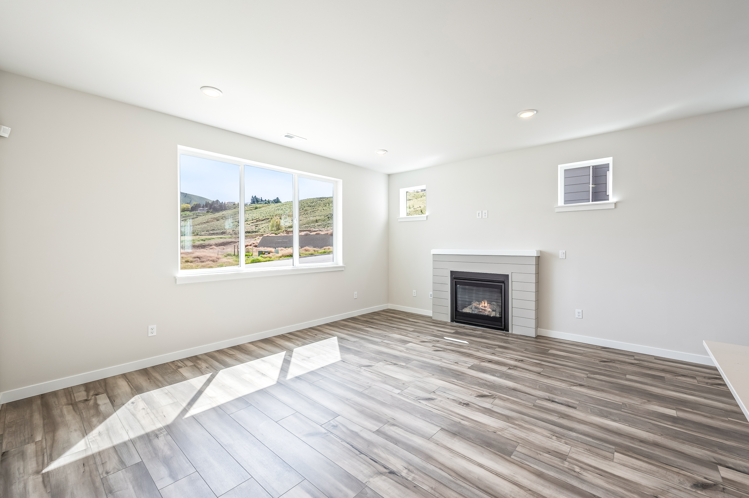 A room with a fireplace and a wood floor.