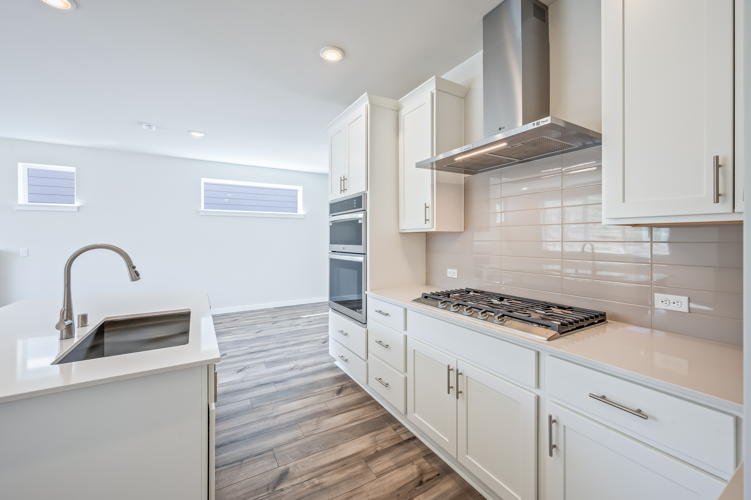 A kitchen with white cabinets.