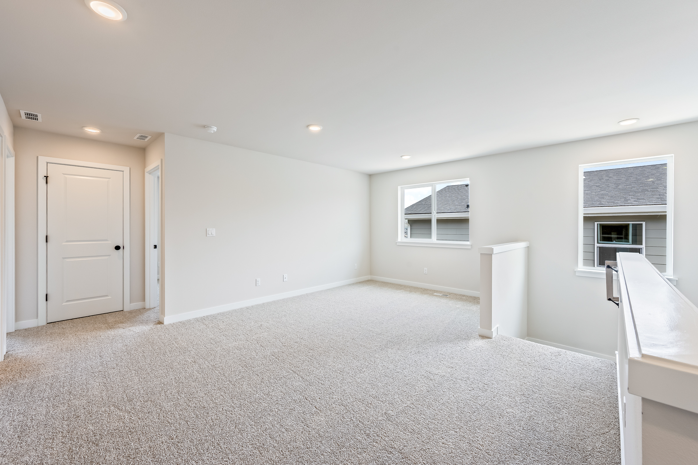 A room with white walls and a white door.