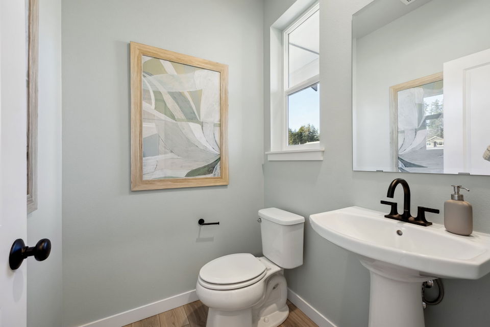 A bathroom with a toilet and sink.