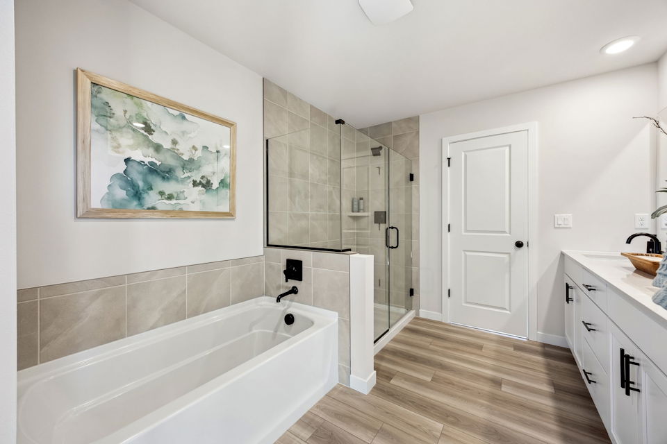 A bathroom with a tub and a shower.