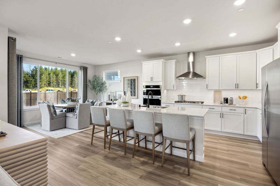 A kitchen with white cabinets.