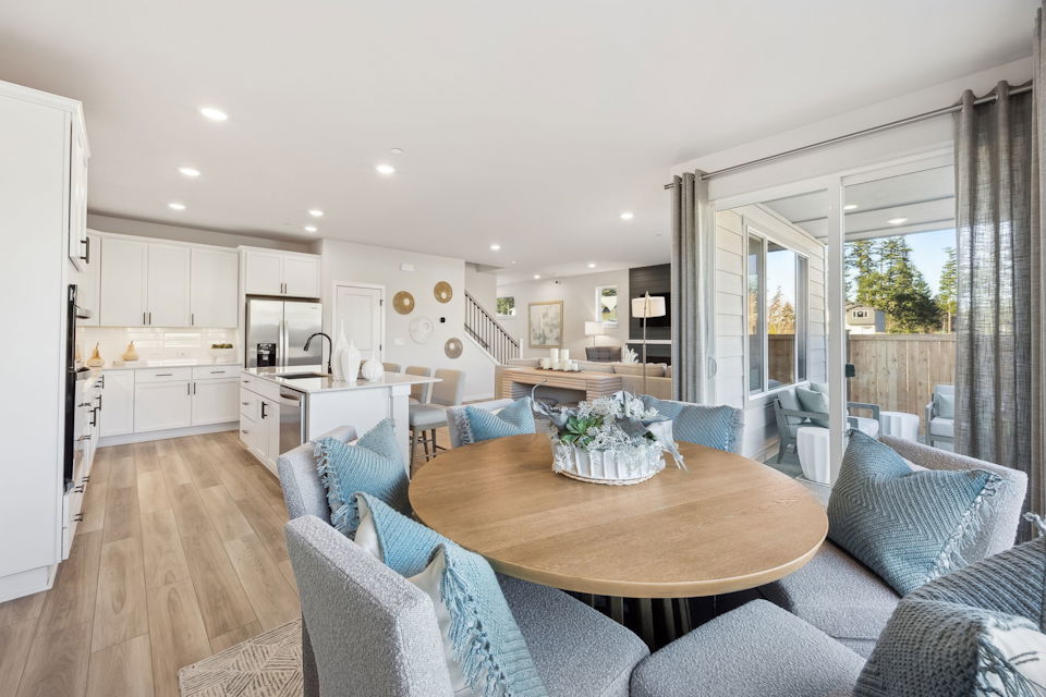 A large kitchen with a dining table.