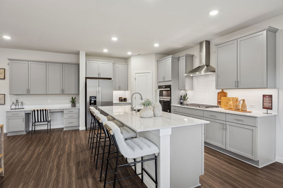 A kitchen with white cabinets.