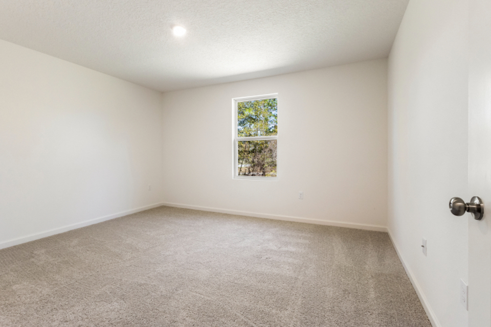 A room with a window and a door.