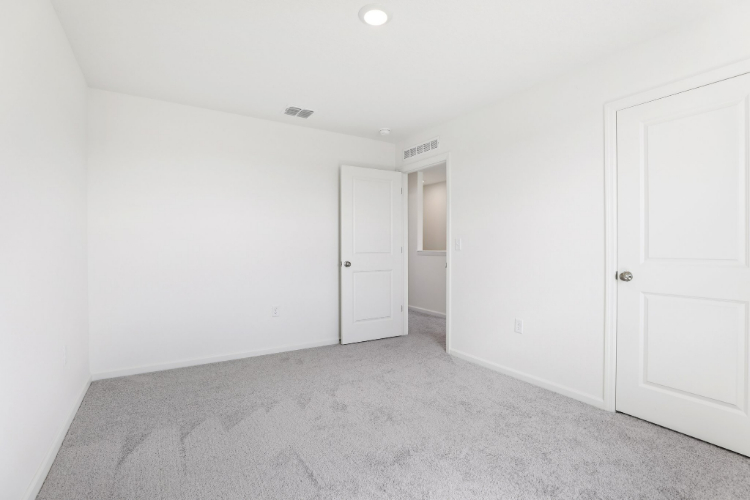 A hallway with white doors.