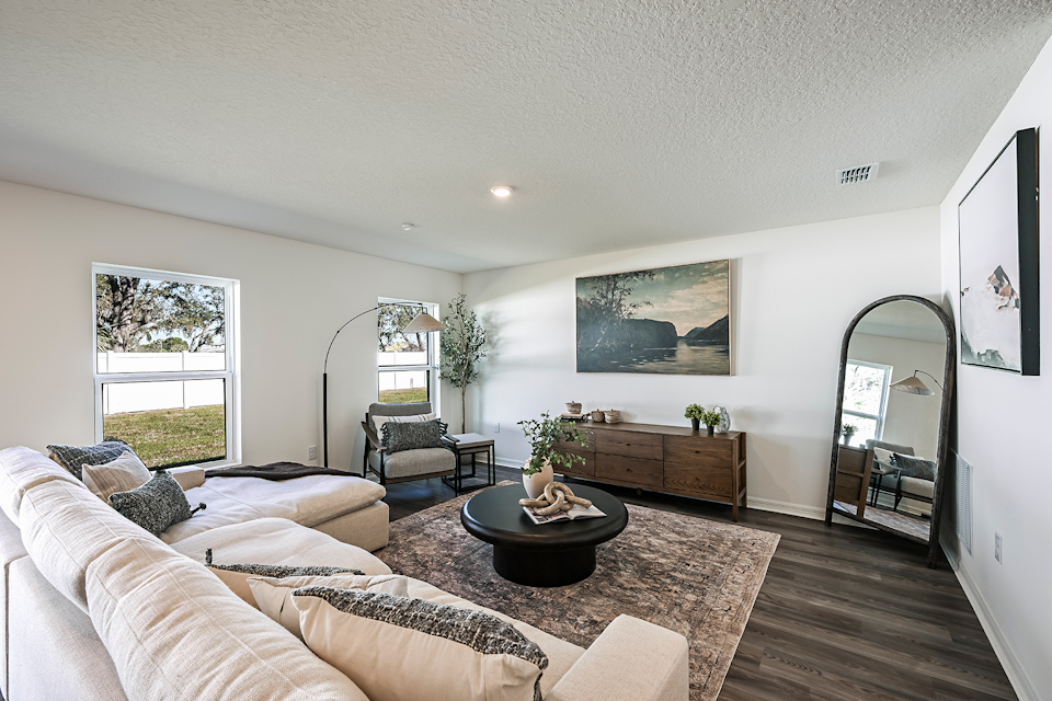 A living room with a large mirror.