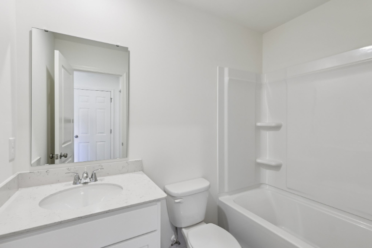 A bathroom with a sink toilet and bathtub.