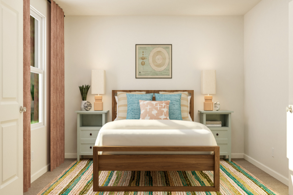 A bedroom with a bed and a dresser.
