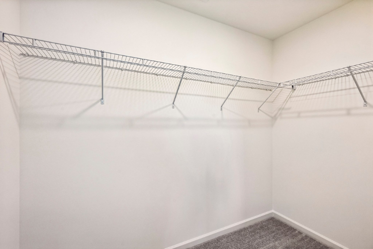 A white wall with a metal railing.