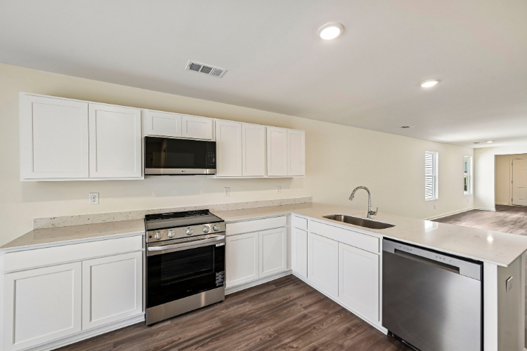 A kitchen with white cabinets.