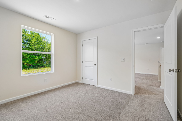 A room with a window and a door.