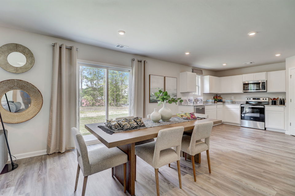 A kitchen with a dining table.