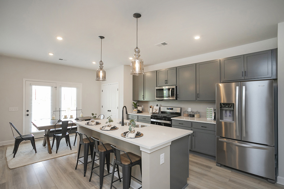A kitchen with a table and chairs.