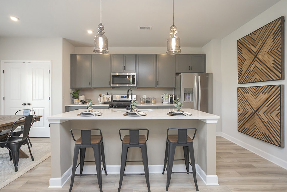 A kitchen with a table and chairs.