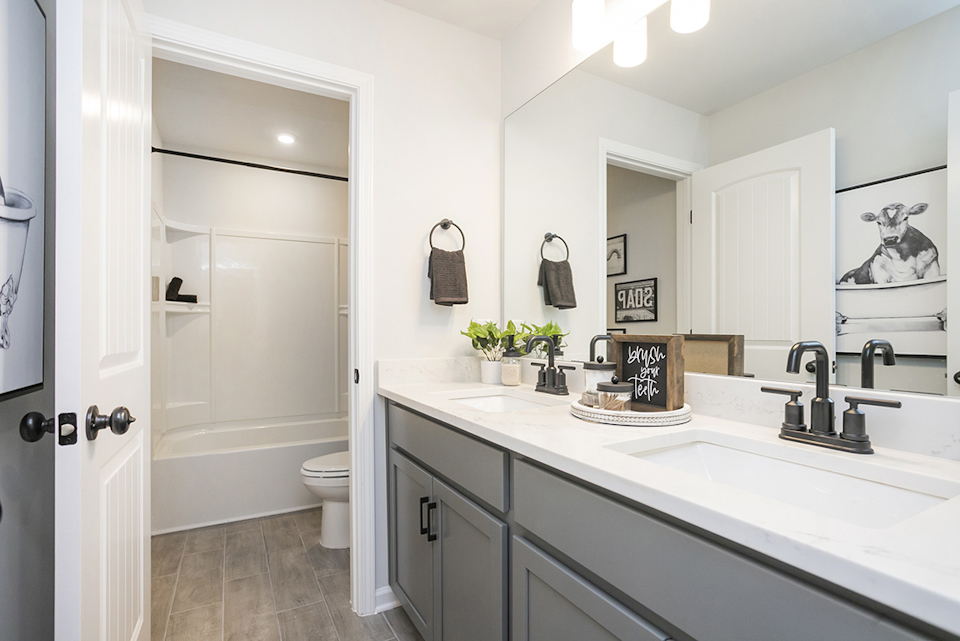 A bathroom with a tub sink and toilet.