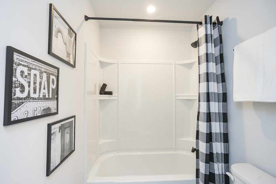 A bathroom with a shower and a bathtub.