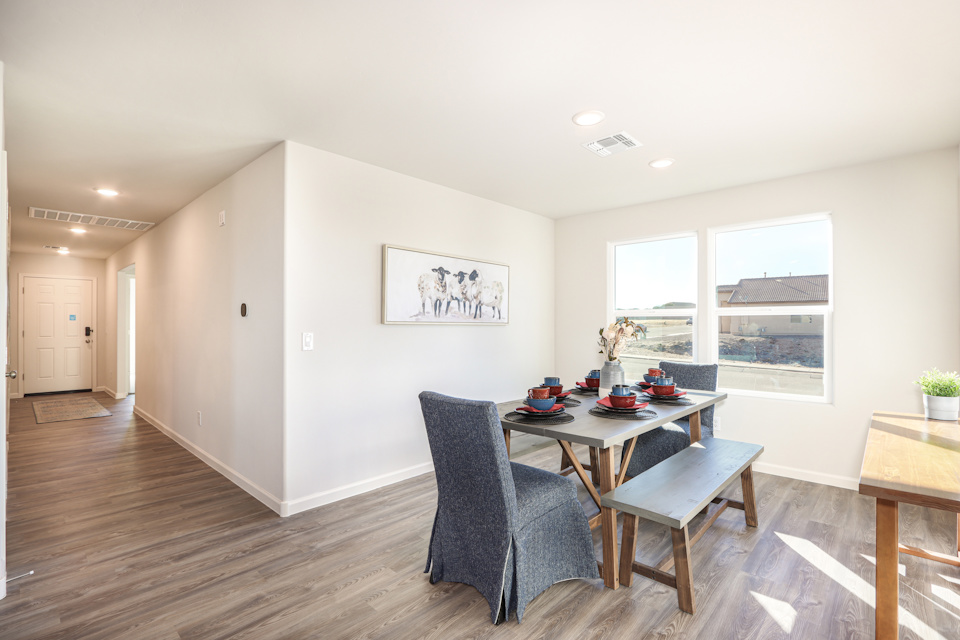 A room with a table chairs and a window.