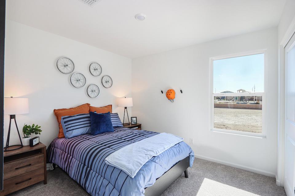 A bedroom with a bed and a window.