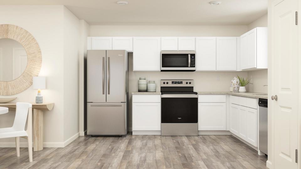 A kitchen with white cabinets.