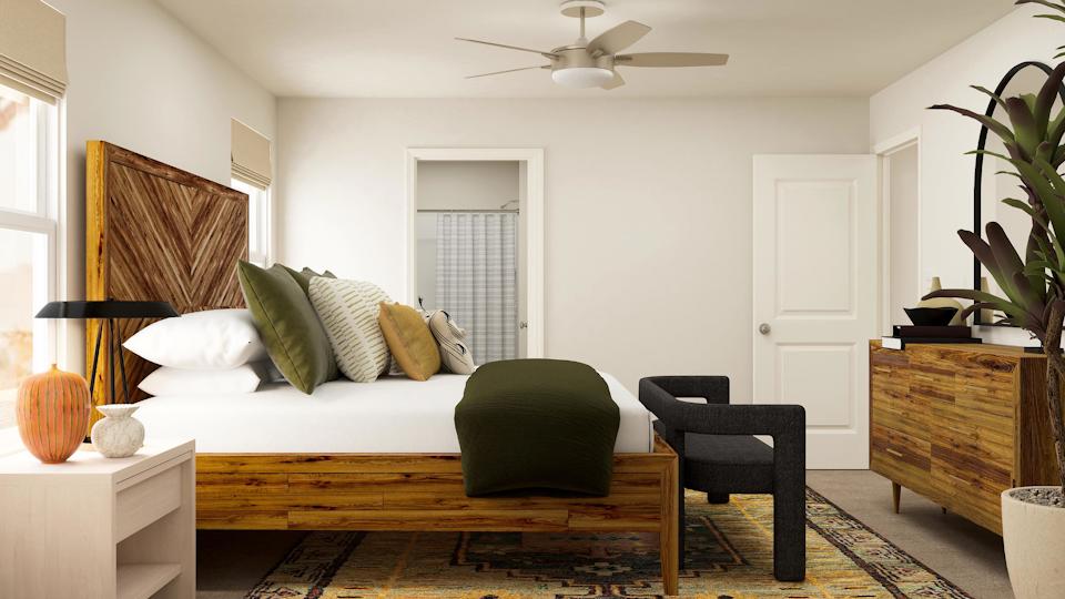 A living room with a couch and a fan.