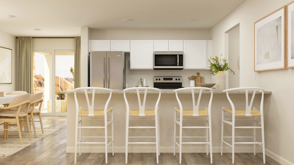 A kitchen with white chairs.
