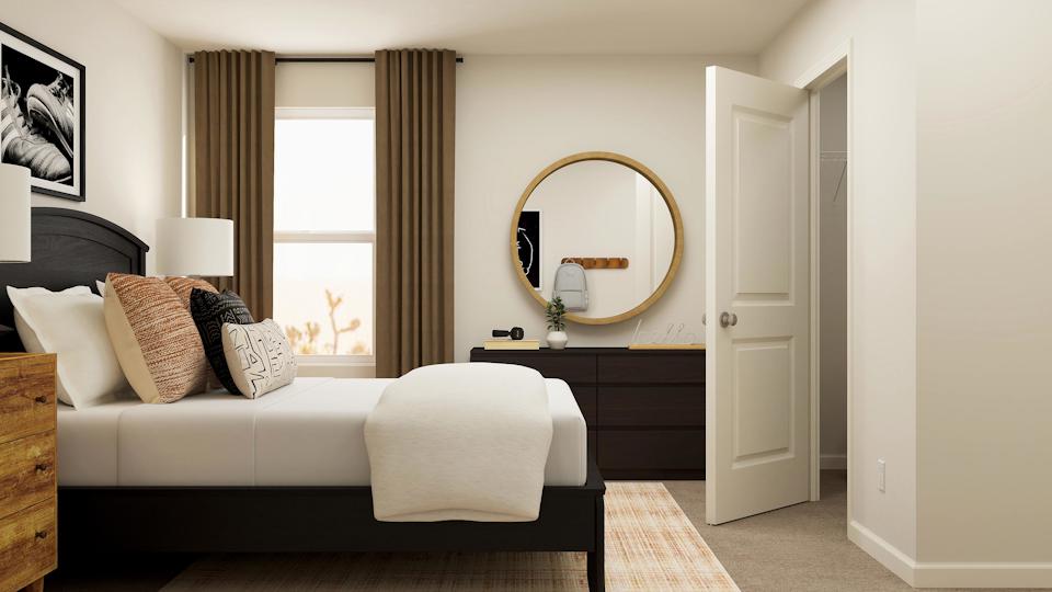 A room with a couch and a mirror.