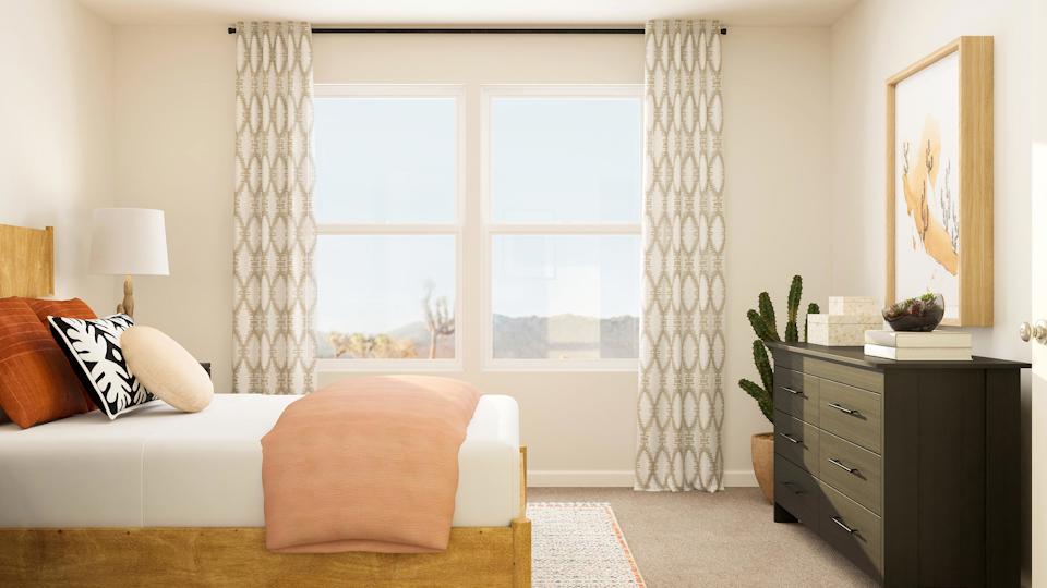 A bedroom with a bed and a chair.