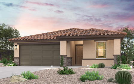 A house with a garage and bushes.