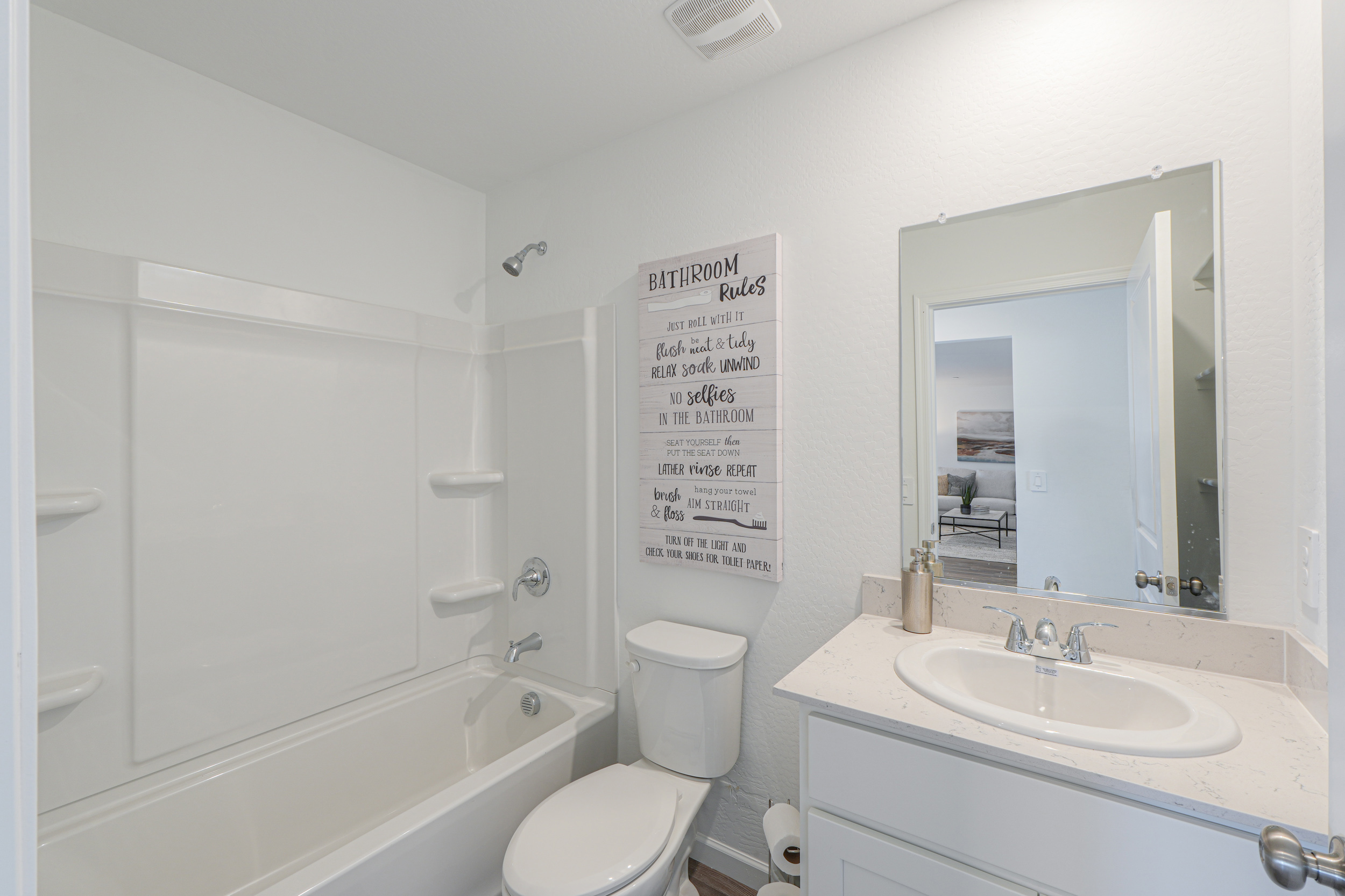 A bathroom with a sign on the wall.