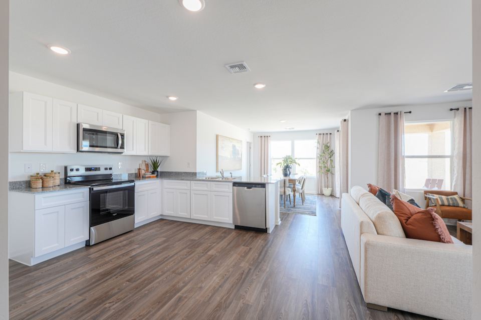A large kitchen with a wood floor.
