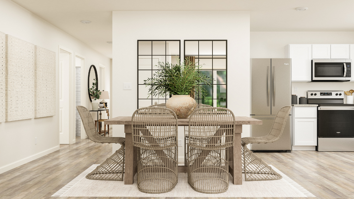 A dining room with a table and chairs.