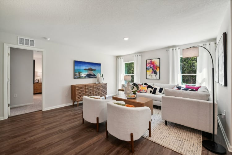 A living room with a couch and chairs.