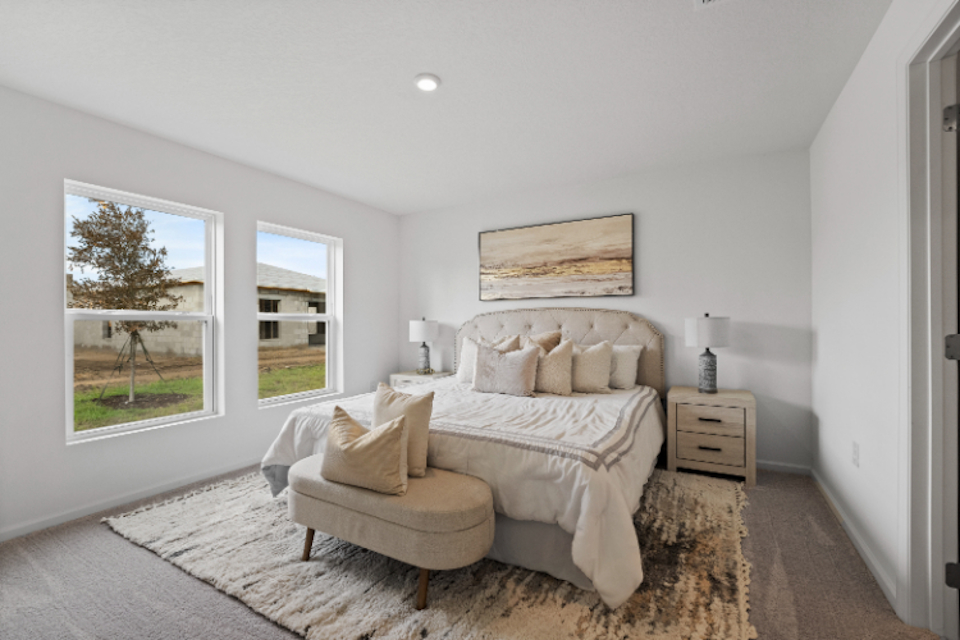 A bedroom with a bed and a couch.