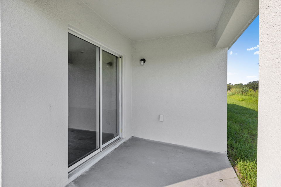 A white building with glass doors.