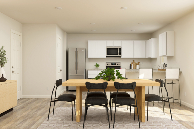 A kitchen with a table and chairs.