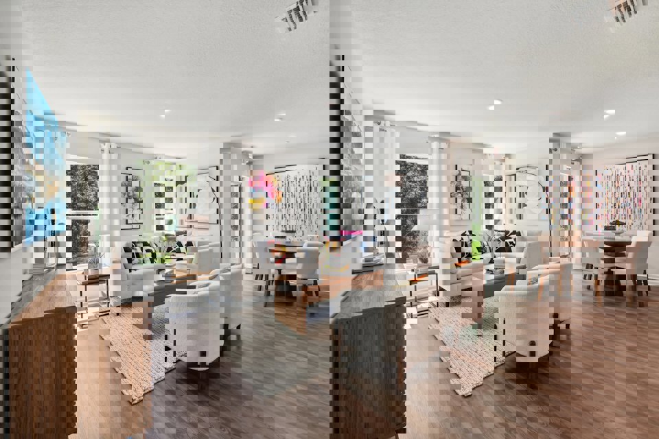 A living room with a large rug.